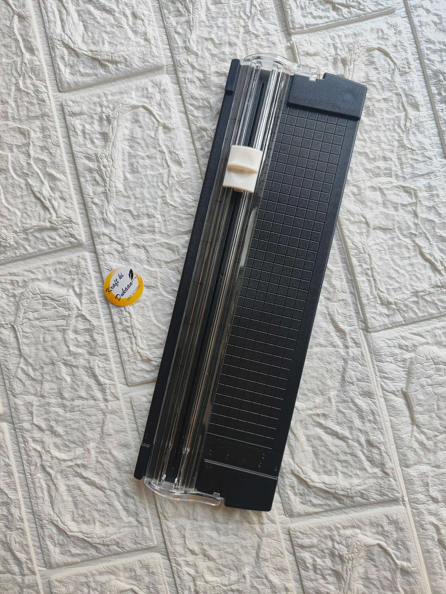 Small paper trimmer cutter with black base, grid guide and metal sliding blade rails