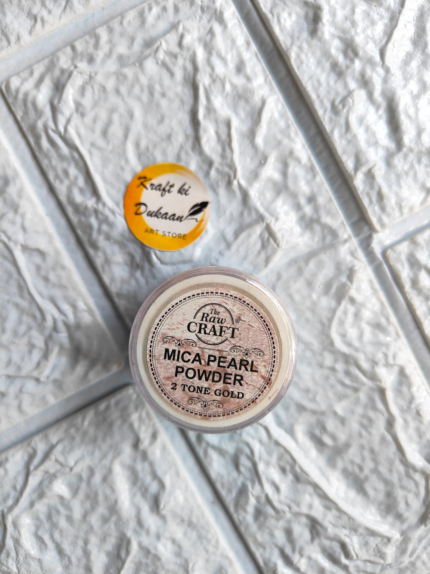 Kraft ki Dukaan MICA pearl powder for resin in two-tone gold packaging on textured background