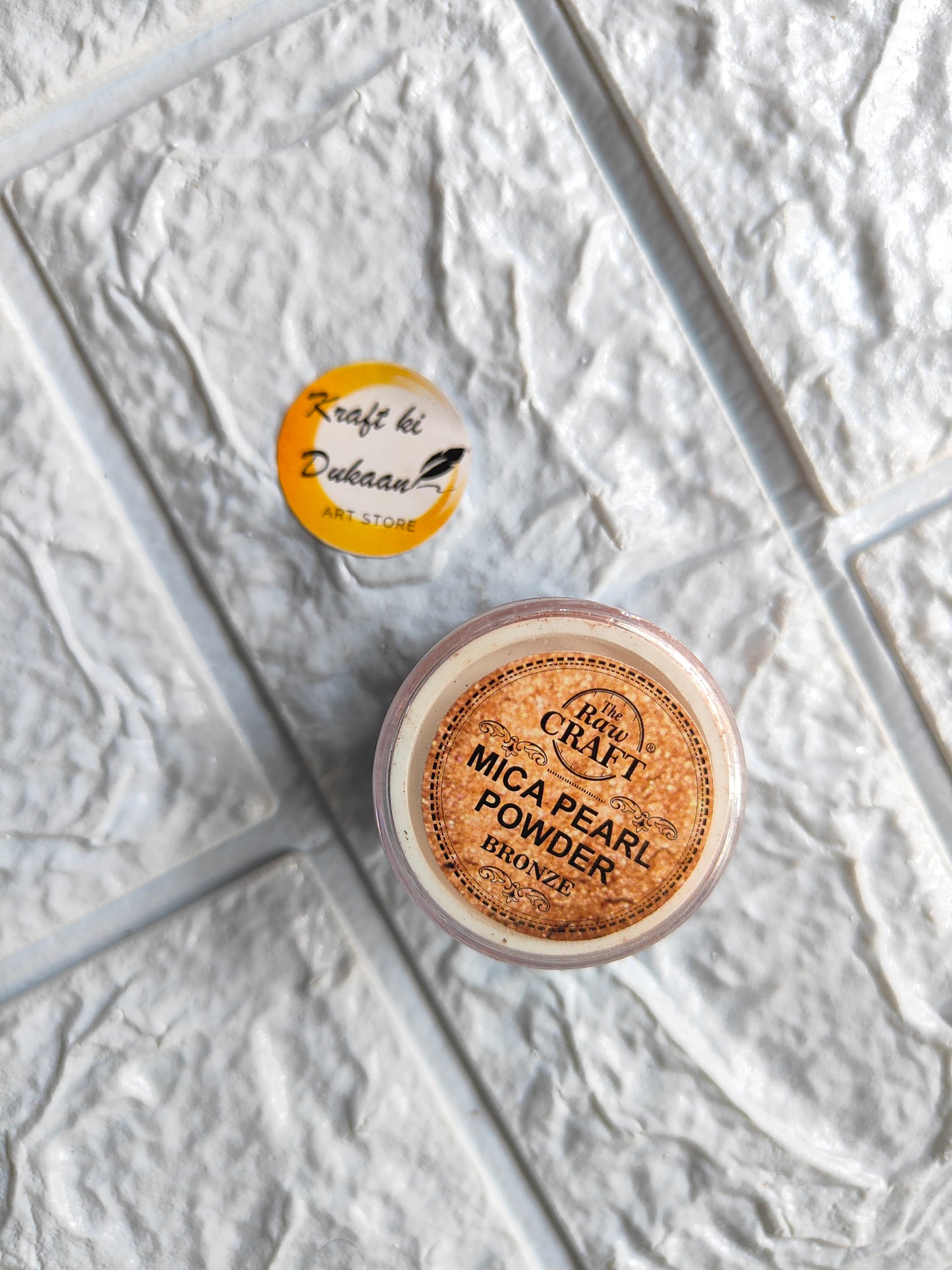 Kraft ki Dukaan MICA pearl powder for resin in a clear container on textured background