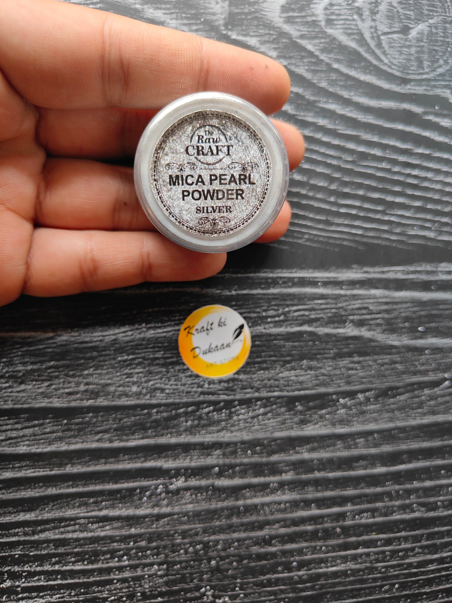 MICA pearl powder for resin in silver tin from Kraft ki Dukaan held in hand with label visible