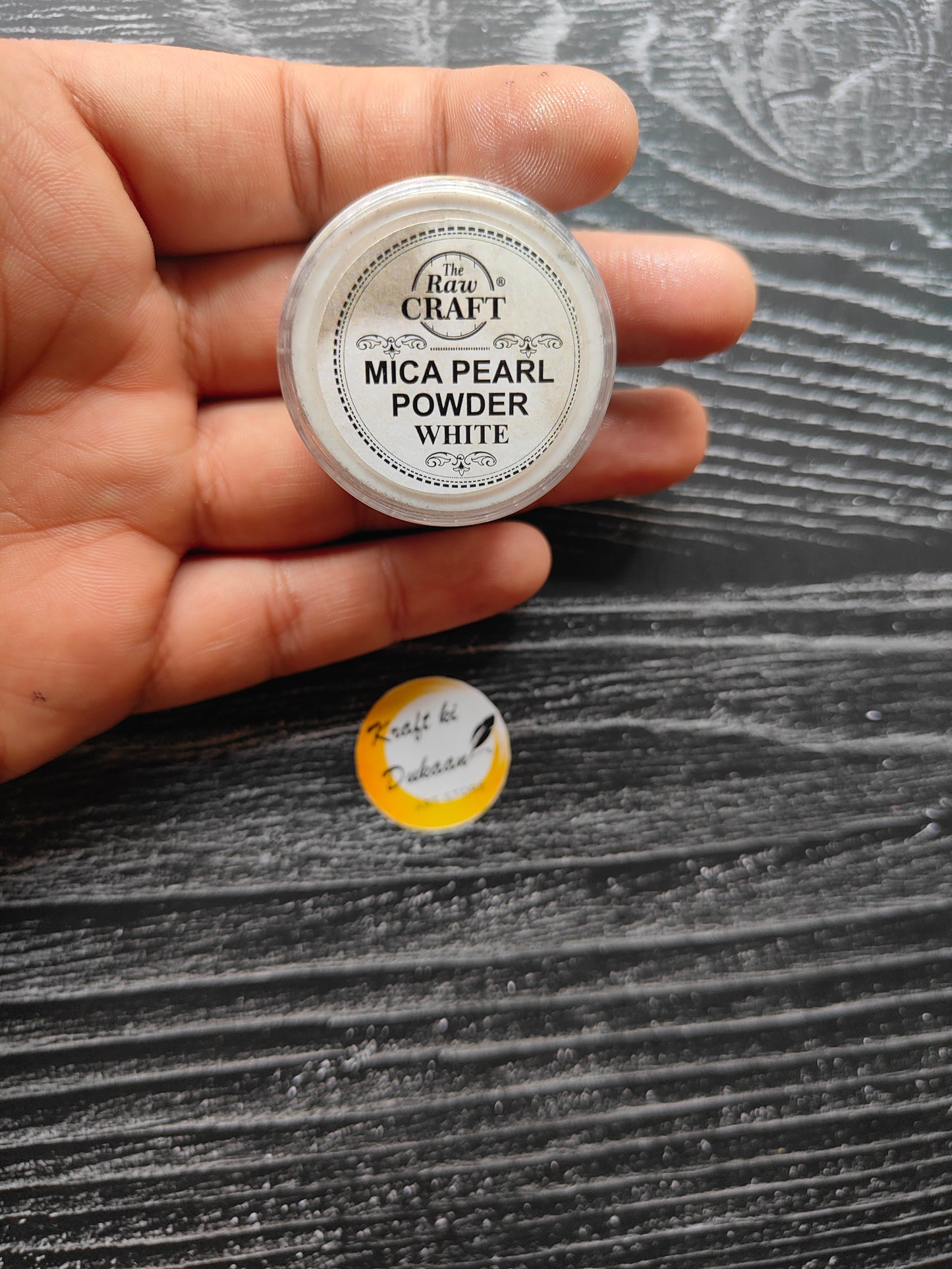 Kraft ki Dukaan MICA pearl powder for resin in a transparent container on a textured black surface