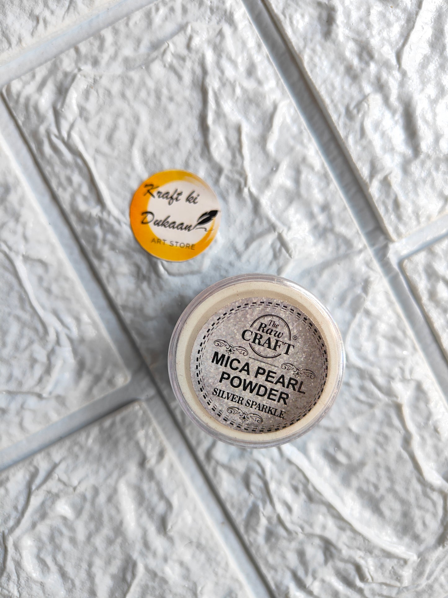Kraft ki Dukaan MICA pearl powder for resin in a clear container with a silver sparkle finish