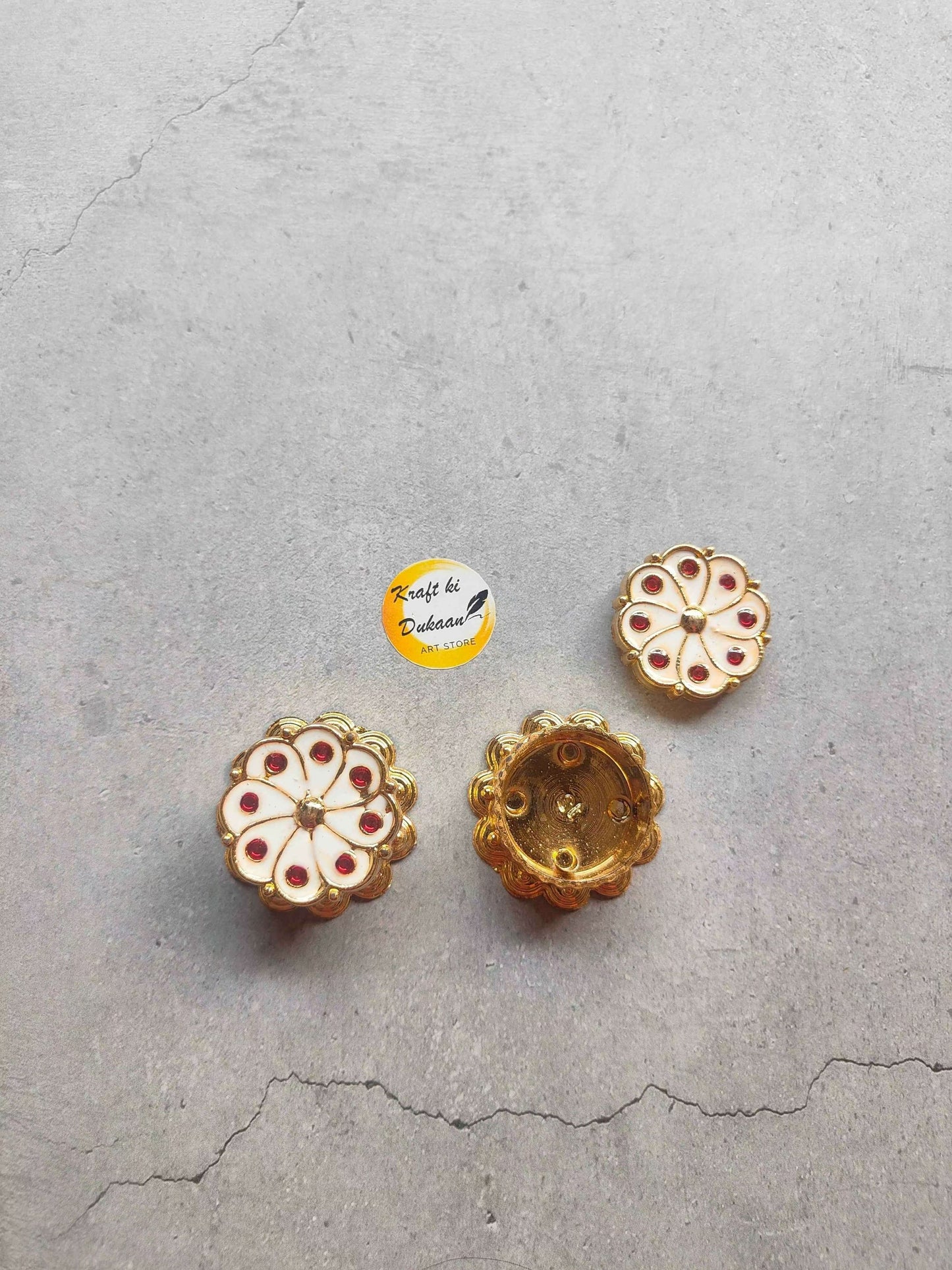 Roli Chawal Box A5: gold-tone circular button set with red-and-white detailing