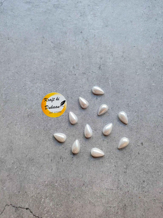 White pearl half-cut drop beads, scattered teardrop bead shapes