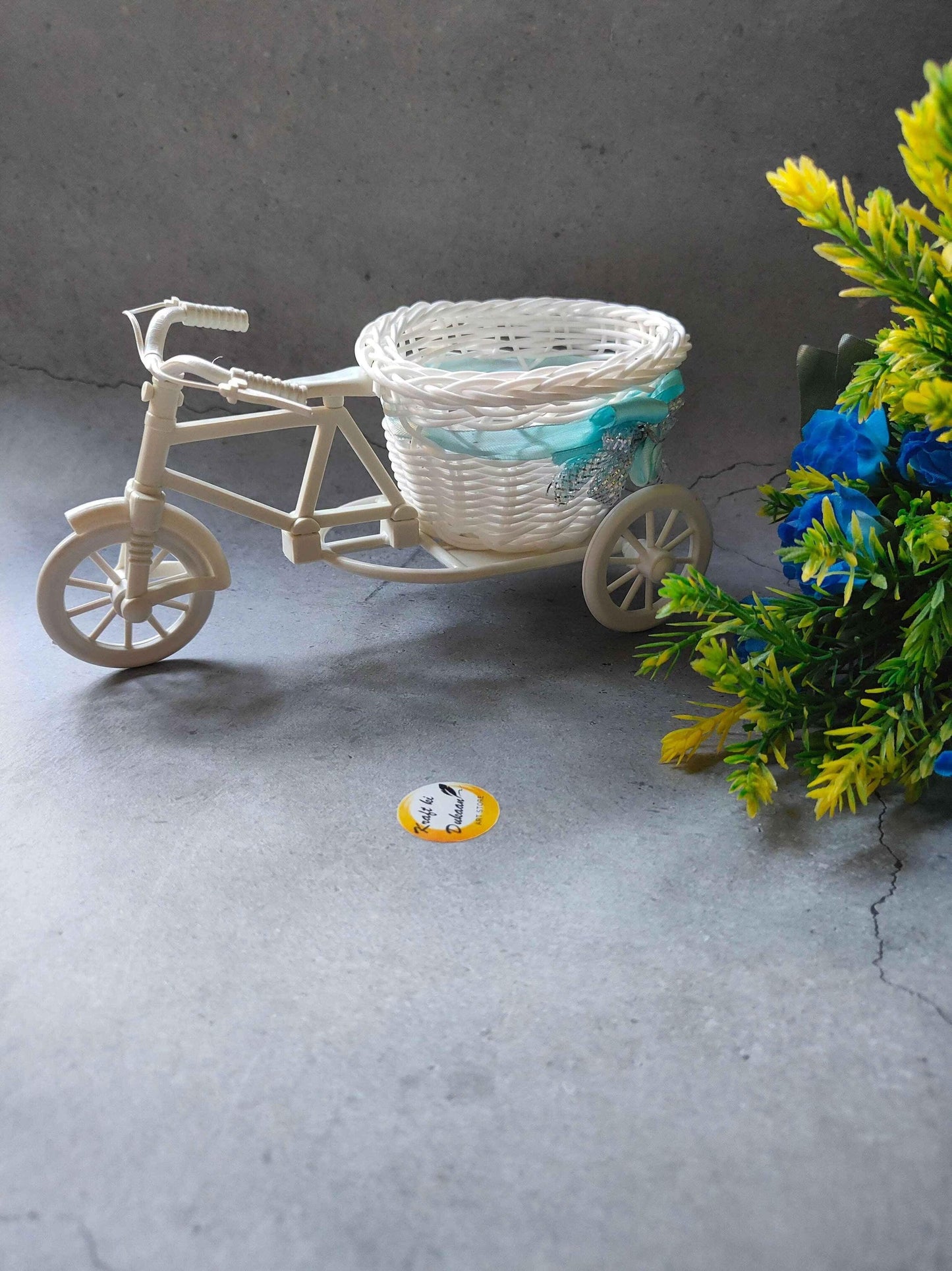 Wicker cycle basket decor in white and blue, perfect for stylish home decoration.
