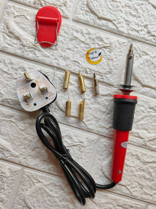 Soldering set contents: red soldering iron with black cable and spare brass nozzles