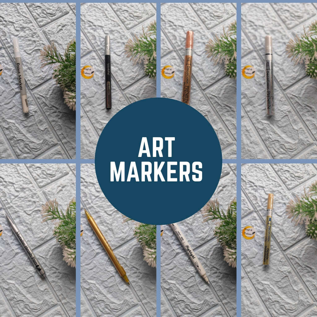 Collection of professional art markers in various colors arranged with greenery on a textured background