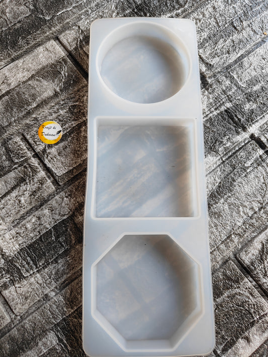 White silicone 3 in 1 paperweight mold with circle, square, and octagon shapes on textured surface