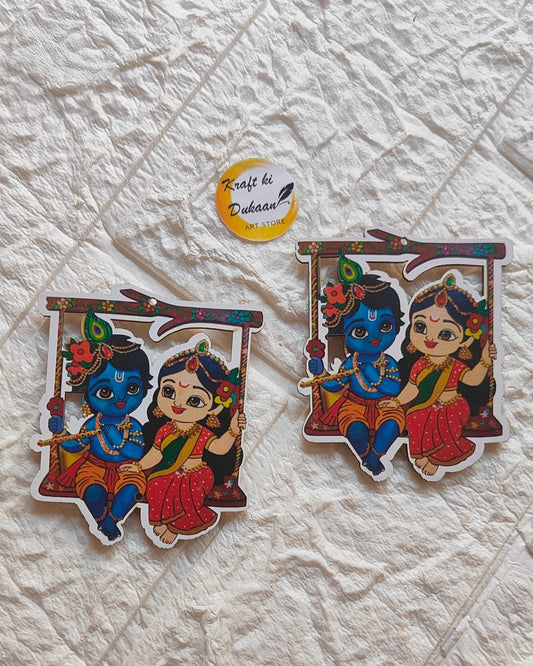 Colorful 3 inch MDF art cutout featuring a playful blue-skinned boy and girl sitting on a swing