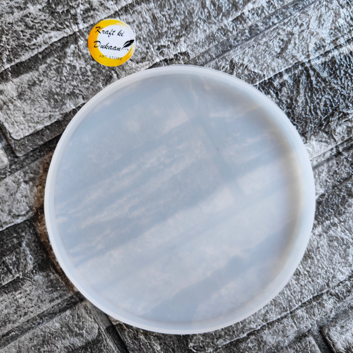 5 inch round resin mold from Kraft ki Dukaan placed on textured stone surface for crafting