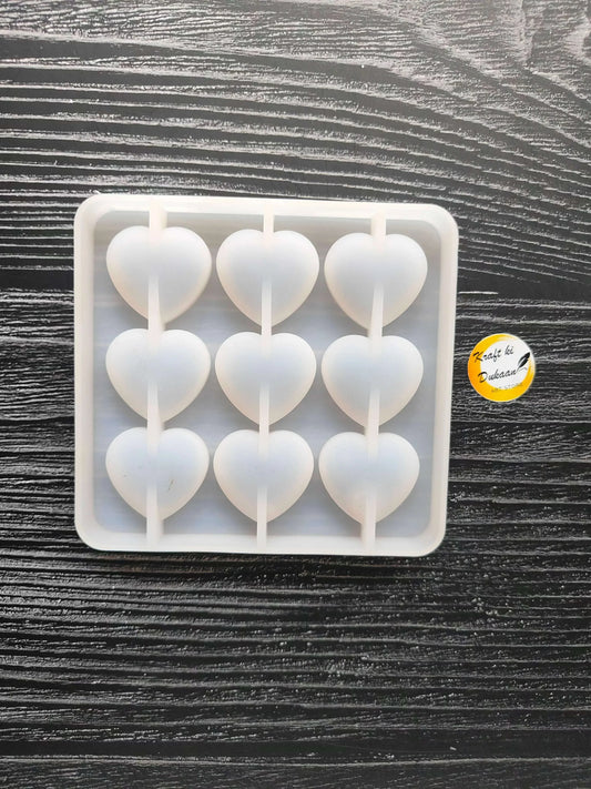 9-cavity heart mould with molded rows of heart wells in silicone tray