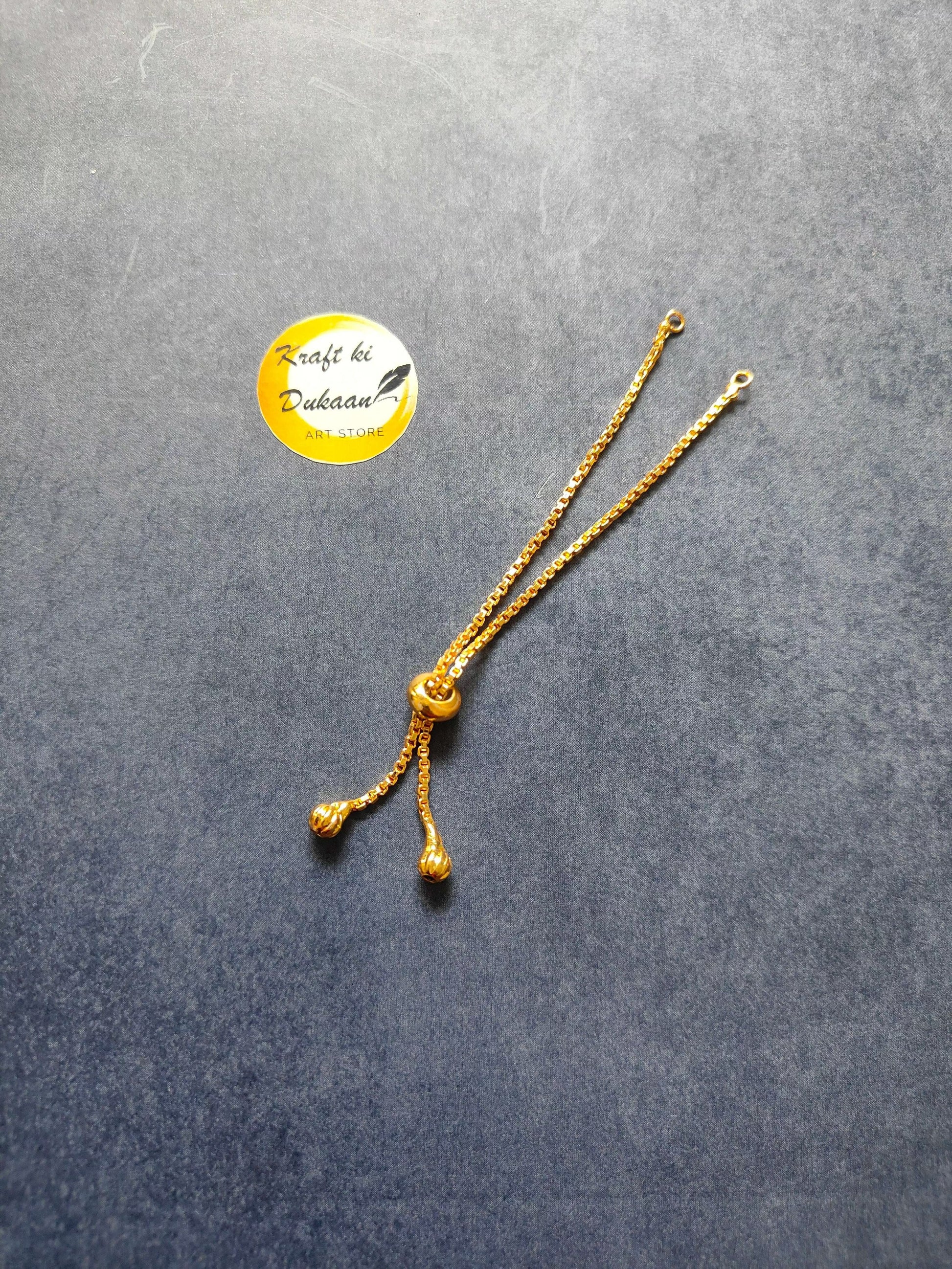 Golden bracelet chain with three small bead dangles and linked clasp