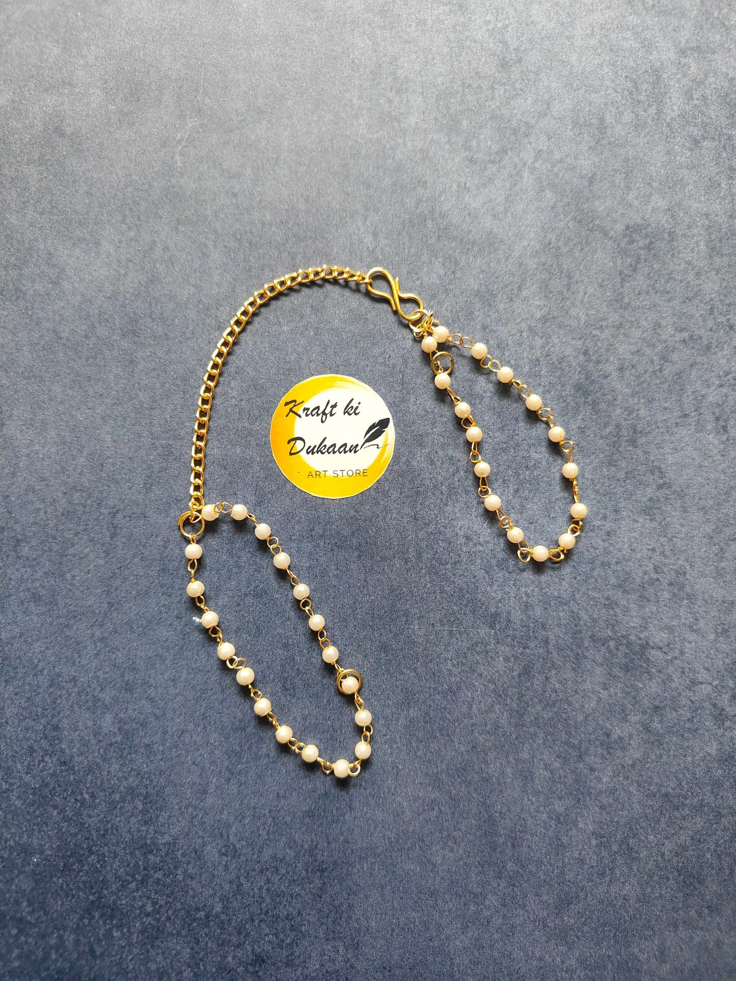 Bracelet chain with gold-tone links and small white pearl beads, clasp included