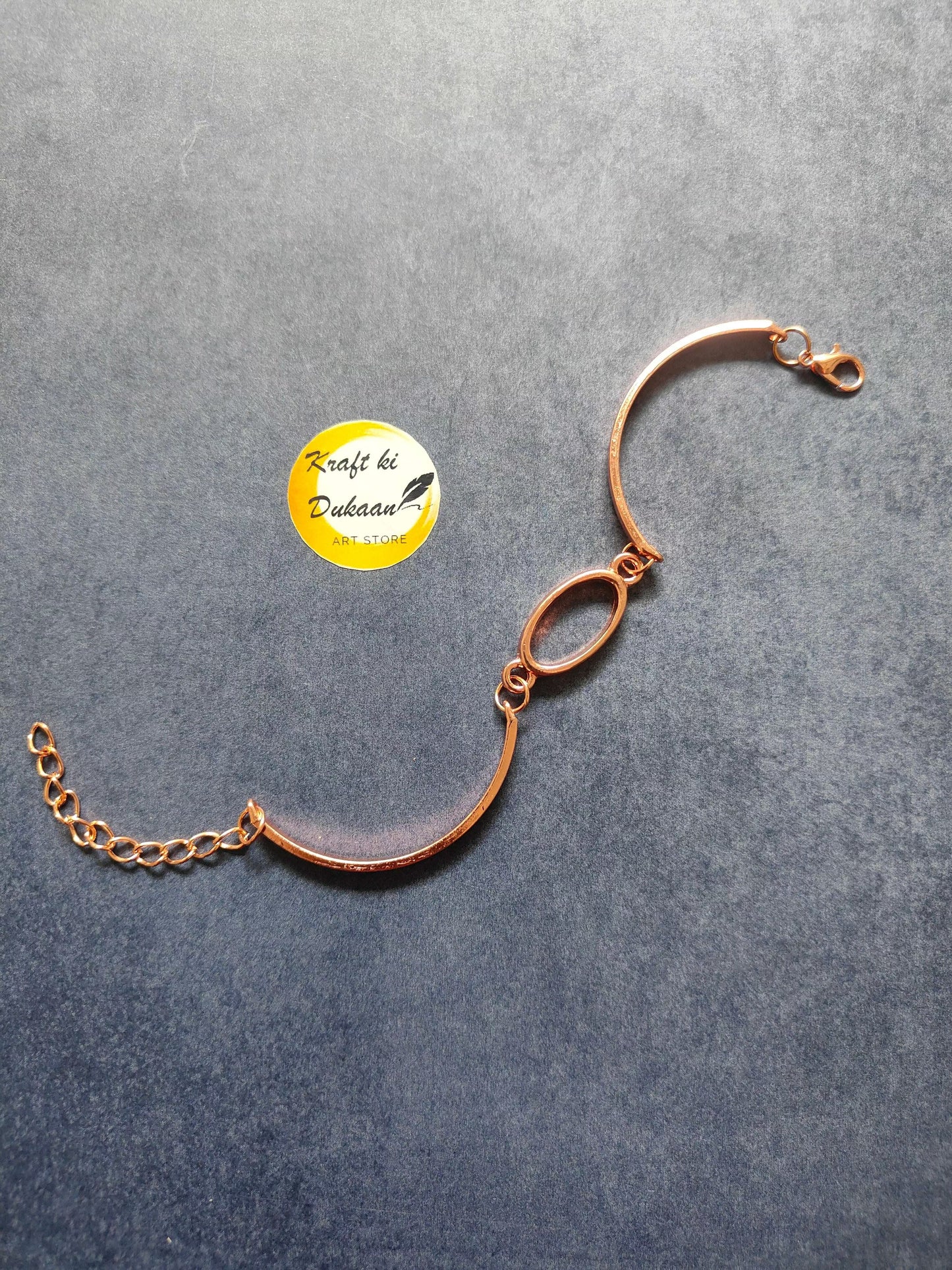 Rose gold oval metal bracelet with linked oval charms and adjustable chain end