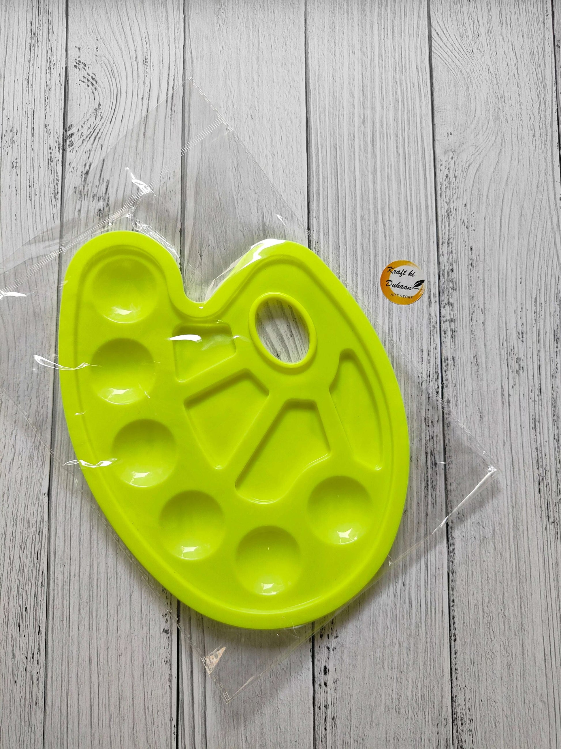 Colour mixing palette tray in neon yellow with round wells and central mixing slots