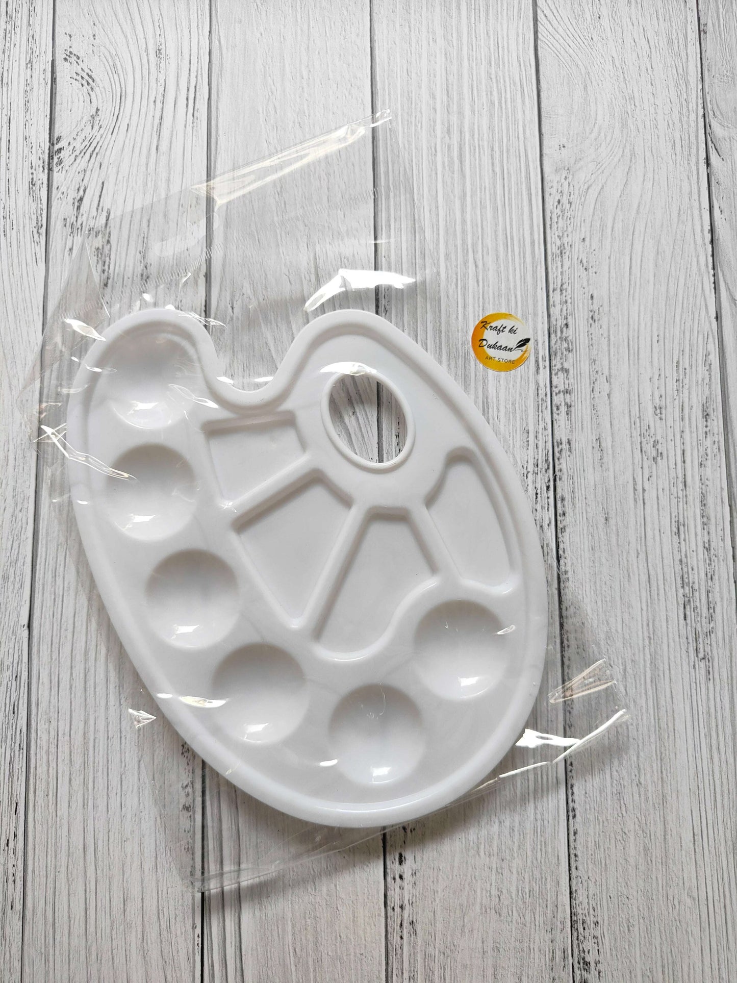 Colour mixing palette tray in white with raised wells and a finger handle cutout