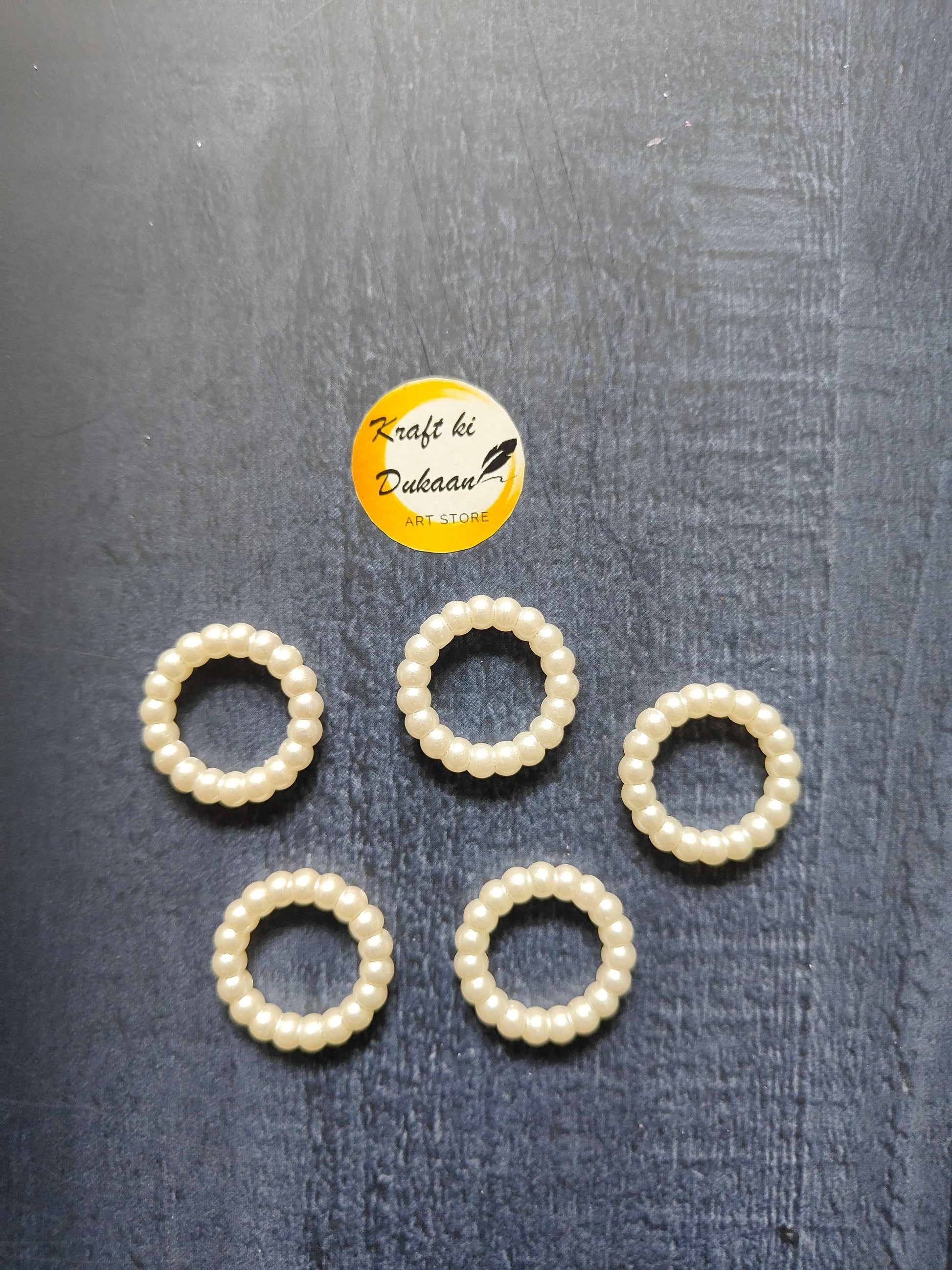 White pearl bead ring set, five circular rings with bead-wrapped band