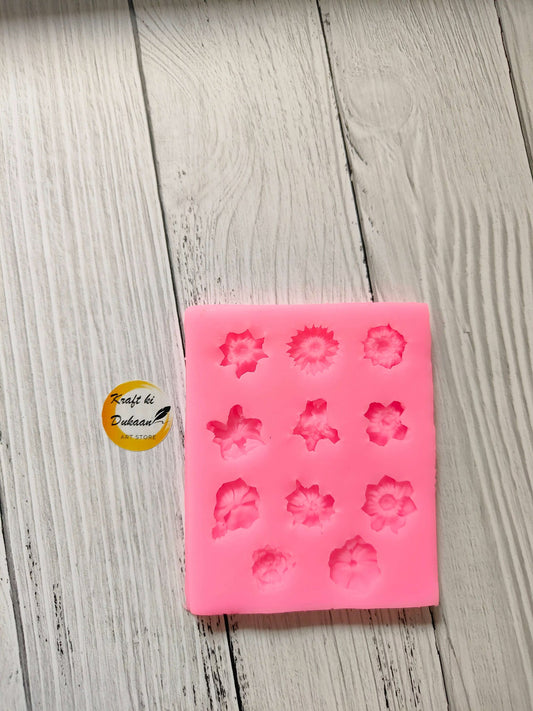 Pink 11-cavity flower silicone mould with raised floral patterns