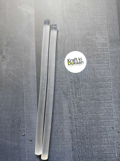 Pack of 2 hot melt glue sticks, clear translucent sticks on a surface