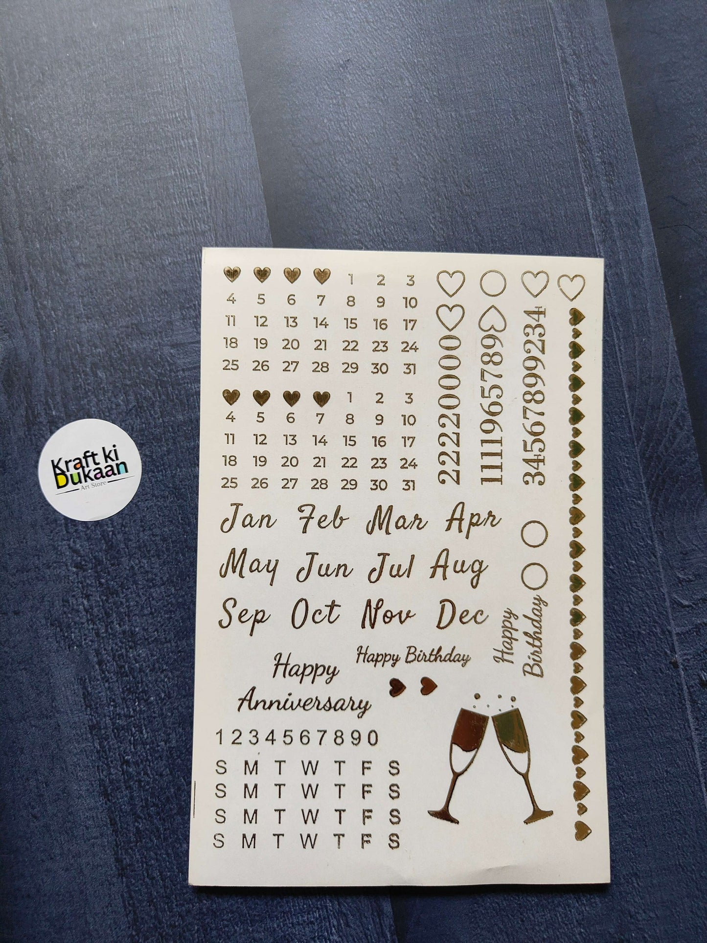 A5 gold embossed sticker sheet with calendar numbers, months, hearts, and champagne glasses