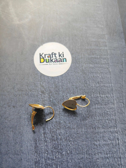 Gold heart earring bases with hinged open tops on fabric