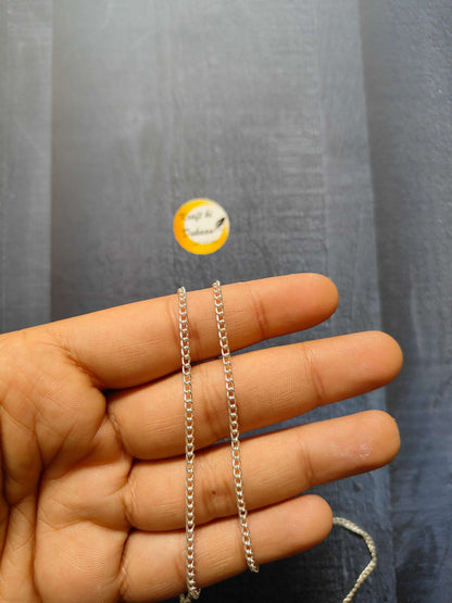 Jewellery Chain: silver curb-link chain bracelets on fingers