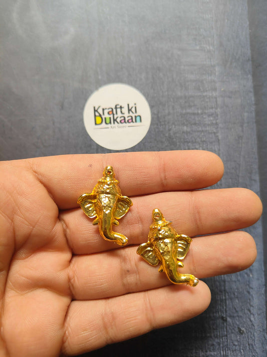 Golden Ganesha face charm, 3cm, shown in hand (pack of 10)