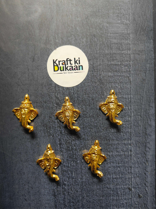 Golden Ganesha face charms, 3cm, five pieces displayed