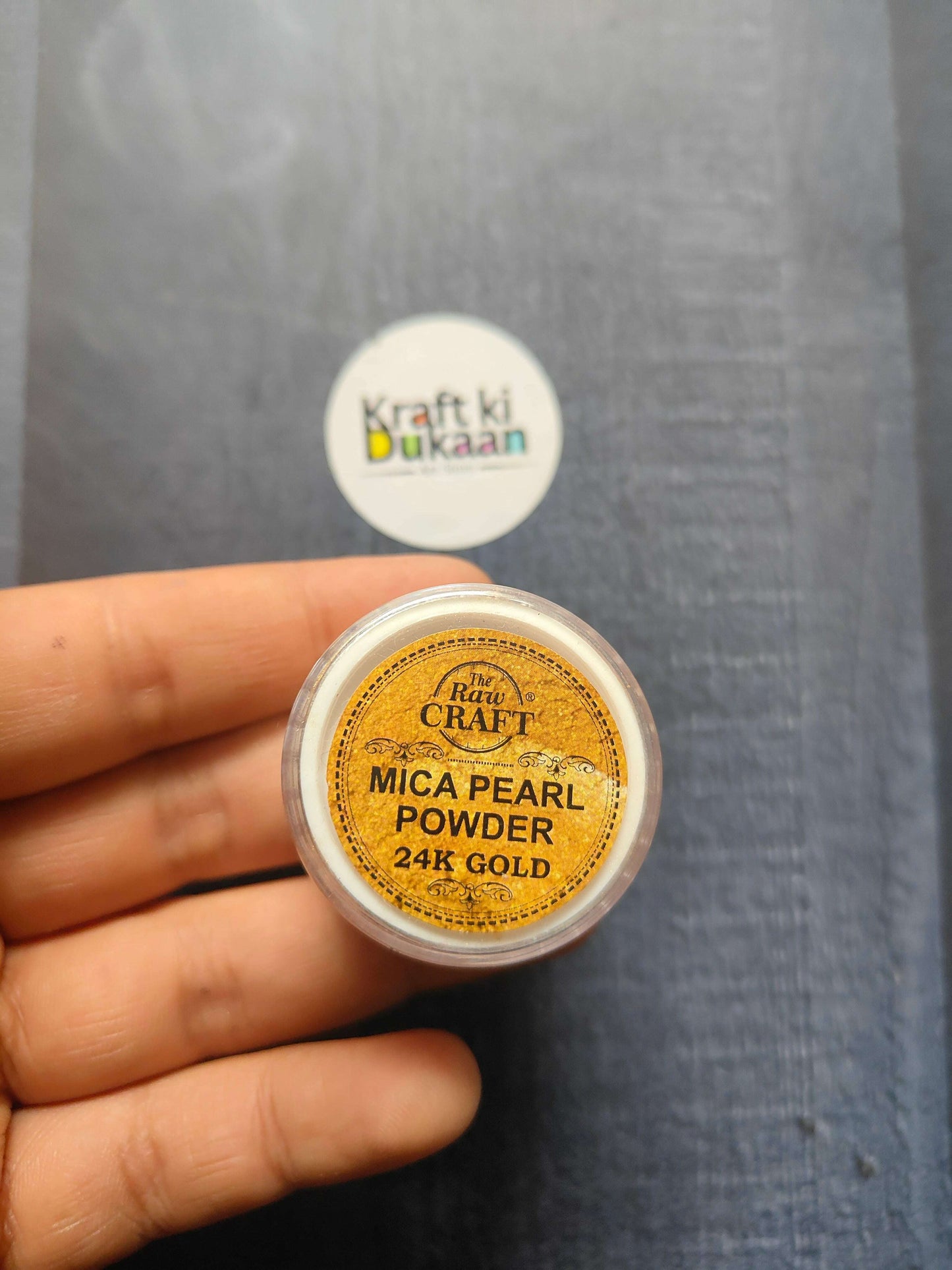 MICA Pearl Powder jar, 24K Gold (15GM) held in hand