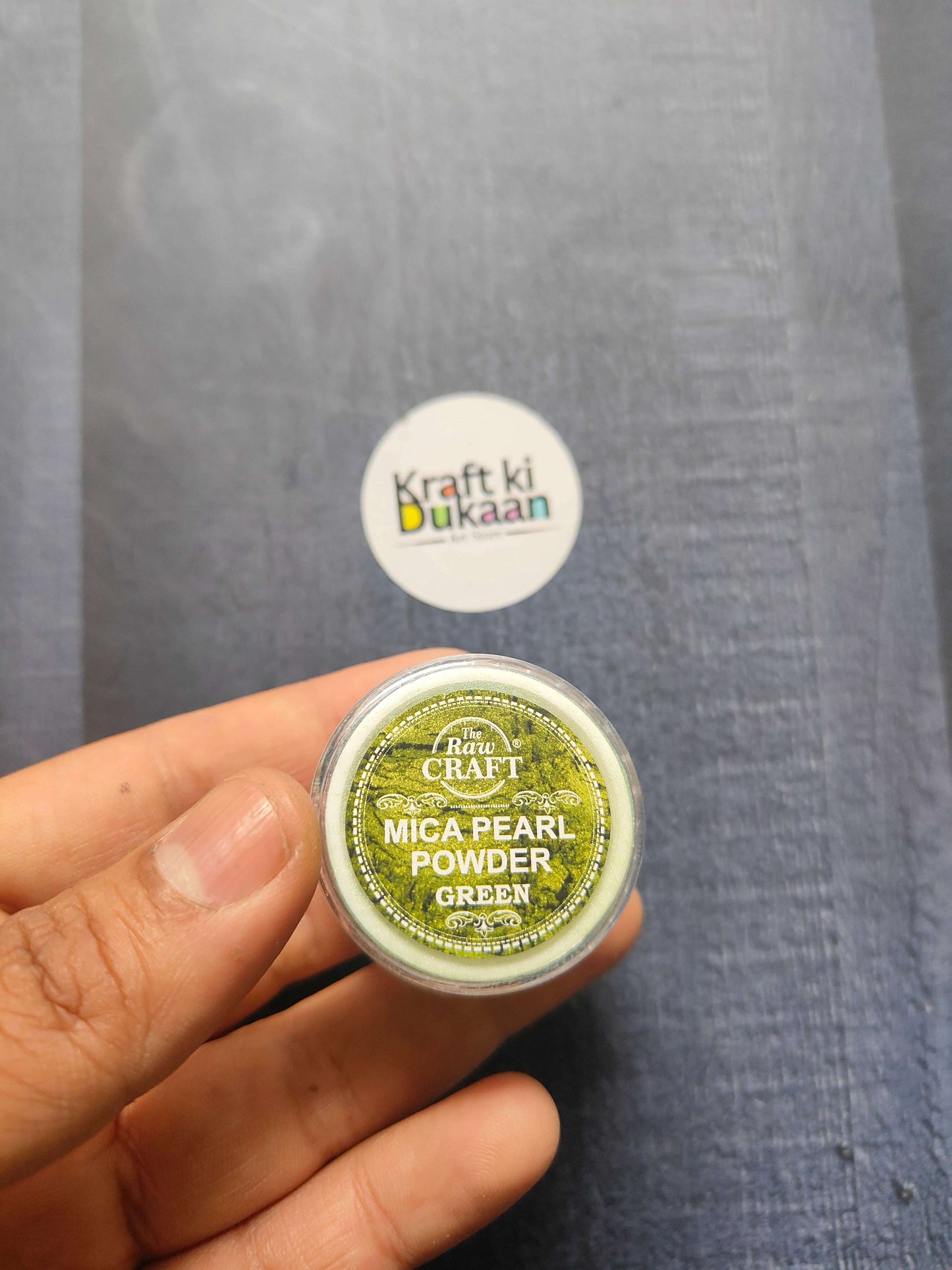 MICA Pearl Powder jar, Green shade (15GM) held in hand