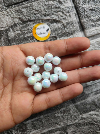 ABS rainbow white beads, close-up of round beads in hand
