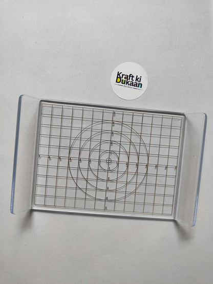 Acrylic clay press plate, top view of concentric circle template on grid