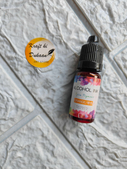 Kraft ki Dukaan orange alcohol ink for resin art in a 15ml dropper bottle on a textured surface