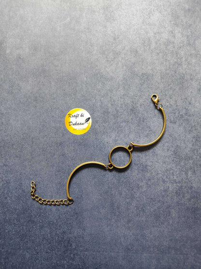 Antique metal bracelet with oval center charm and gold tone chain extender