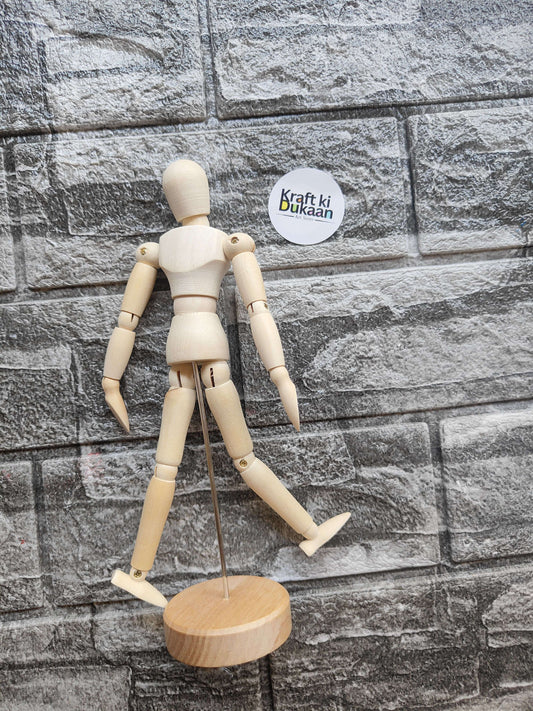 Wooden manikin with articulated arms and legs on round wooden base stand