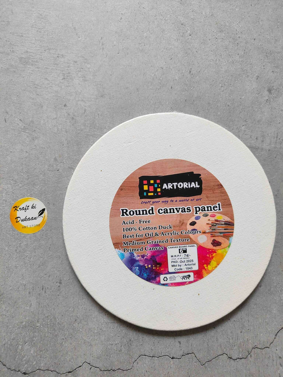 White round canvas panel with printed label at center