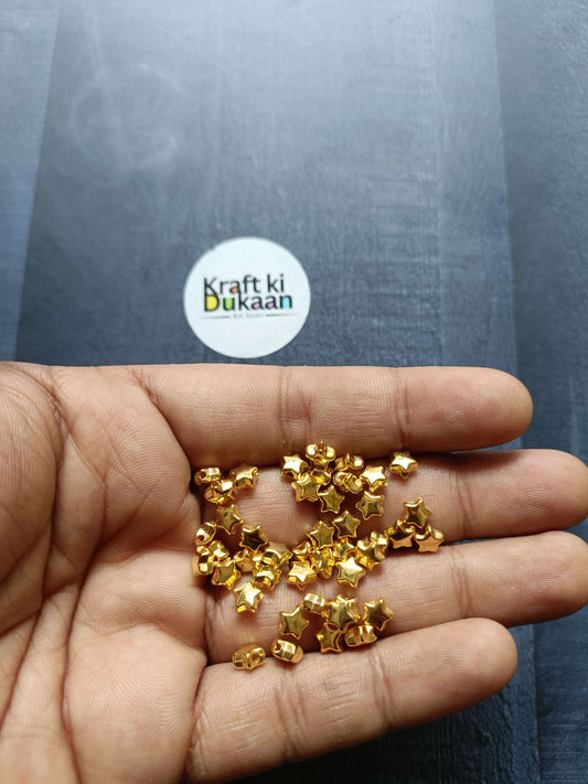 Golden star beads, small gold star-shaped beads in palm, pack of 10GM