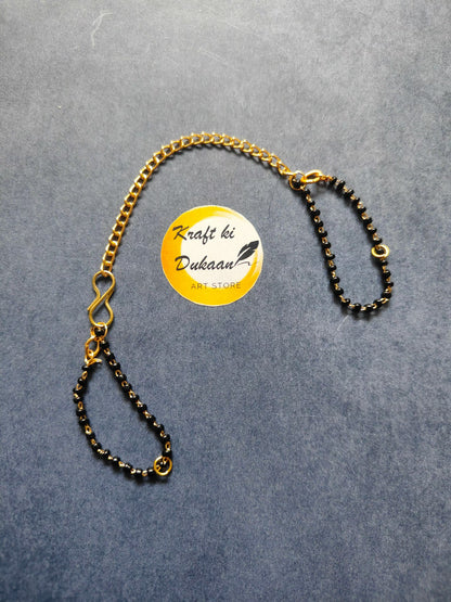 Rakhi bracelet chain with gold-tone curb links and black bead strand, ring clasp