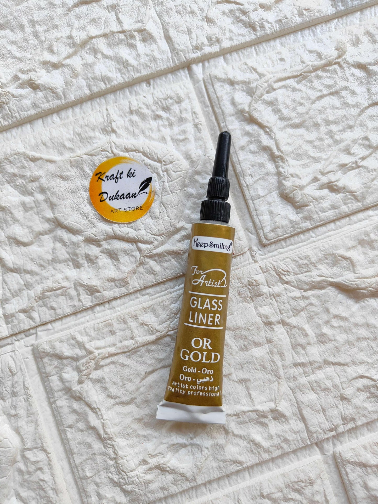 Keep-Breathing gold glass liner tube for resin art with precise applicator tip on textured background