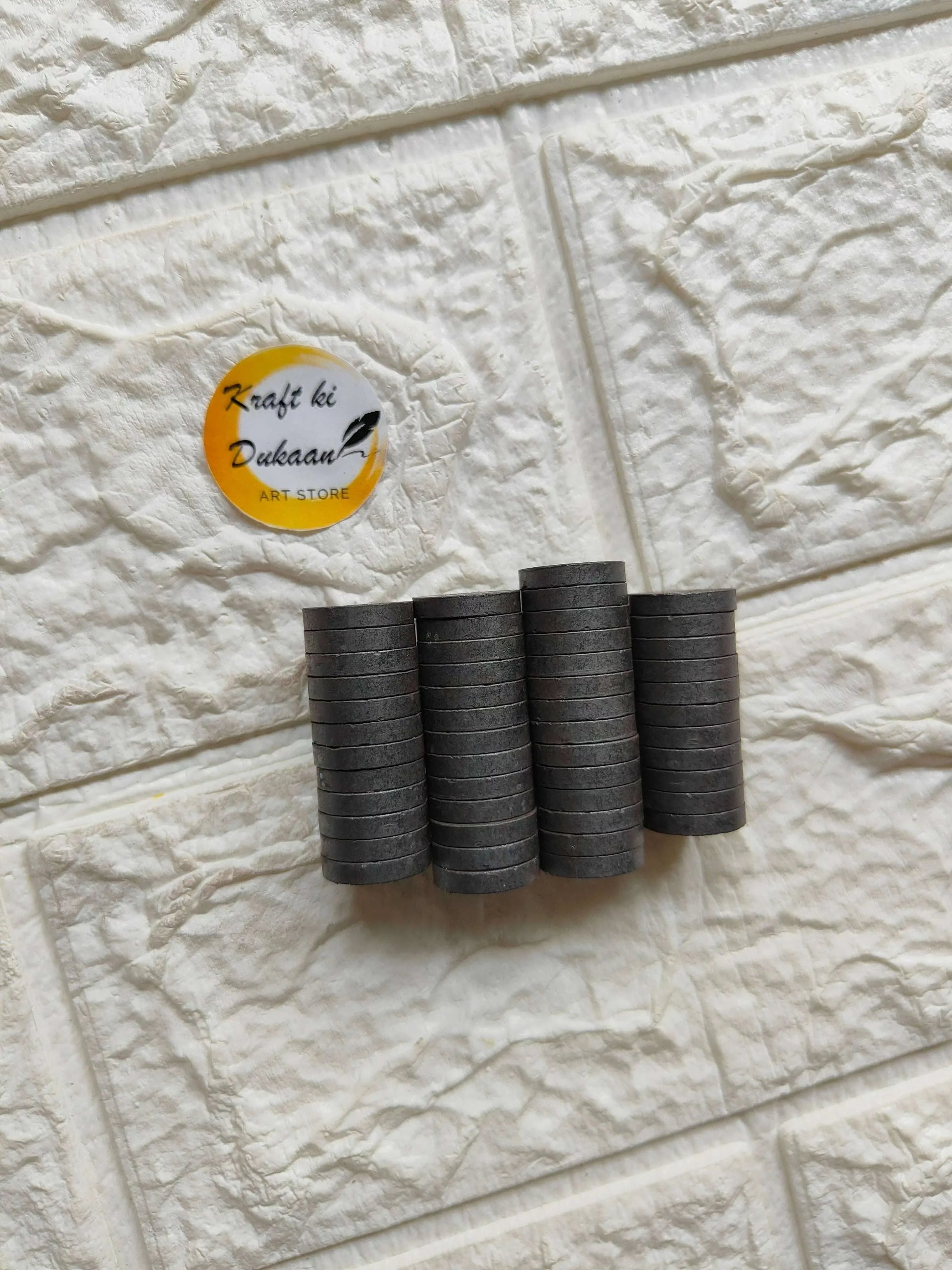 Stacked black round magnets (15mm x 3mm), multiple discs, pack of 50