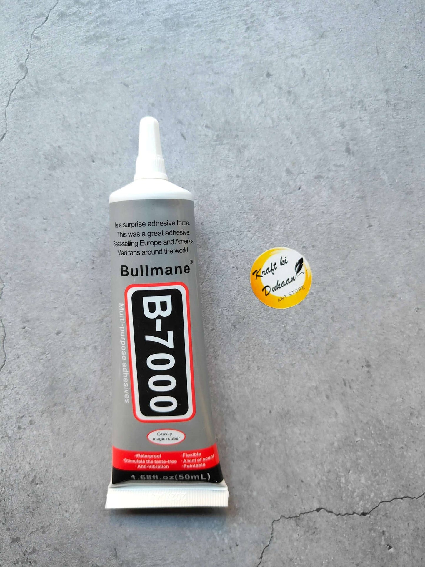 B7000 multi purpose glue tube on a gray surface, ideal for crafts and repairs