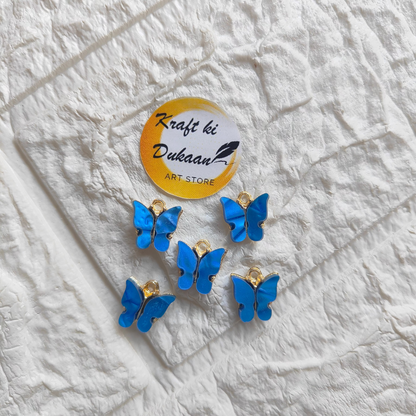 Six blue butterfly resin pendant charms for crafting and jewelry making from Kraft ki Dukaan