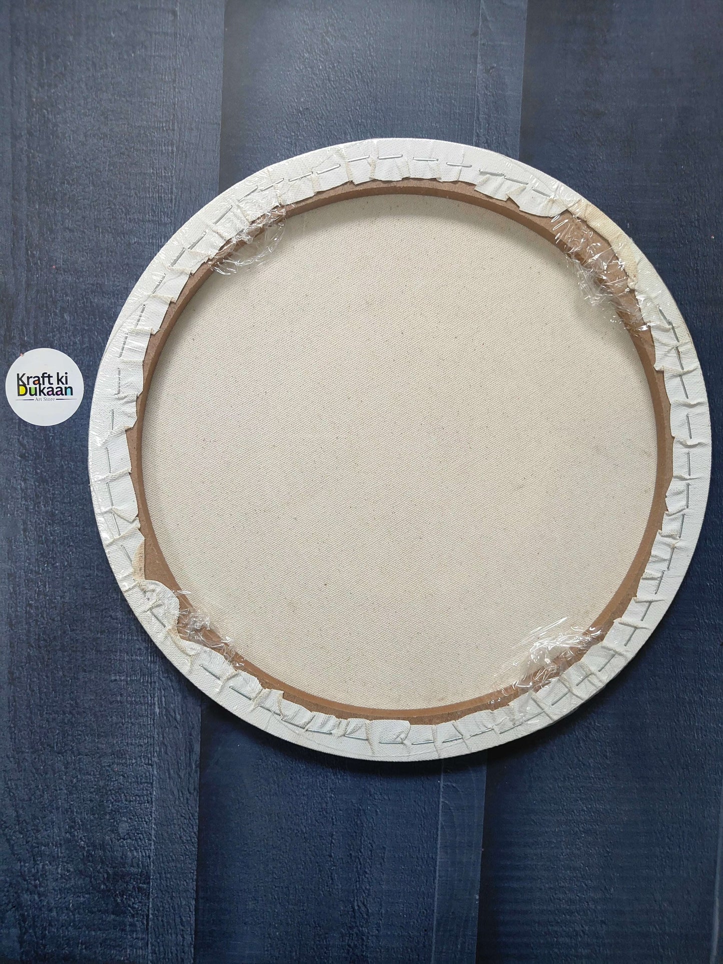 Round stretched canvas board with frame, back view with wooden backing