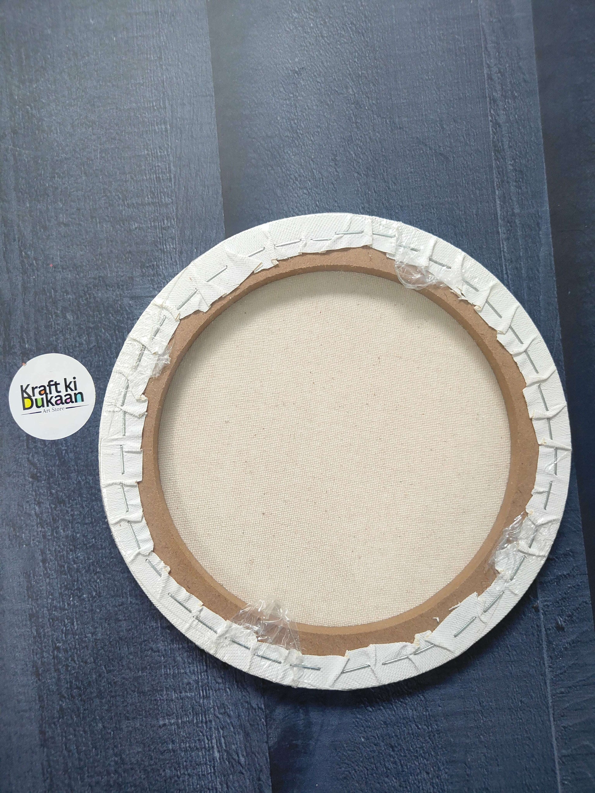Round stretched canvas board with frame, back view showing stapled edges