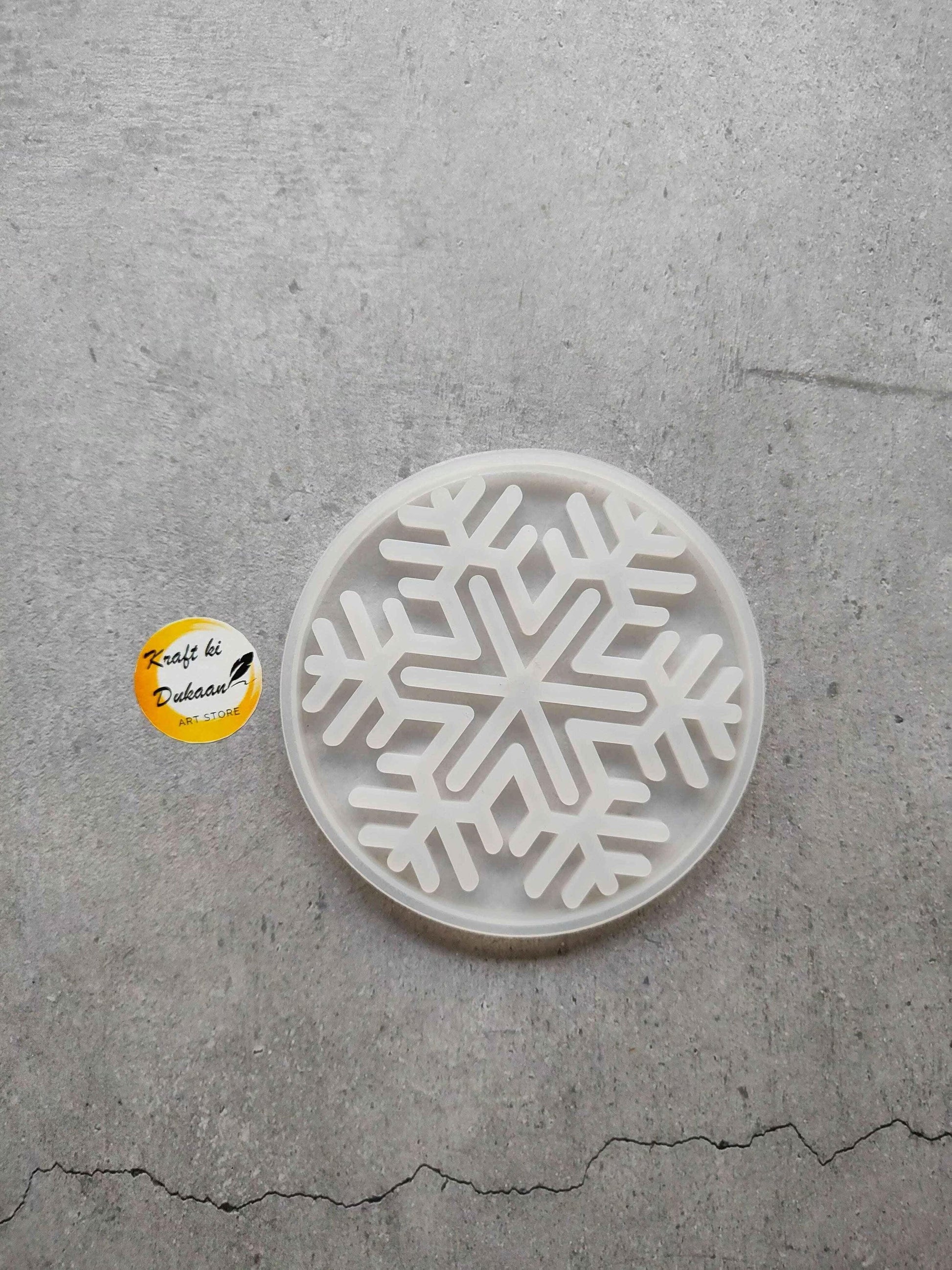 Round Christmas flakes mould with embossed snowflake pattern in white