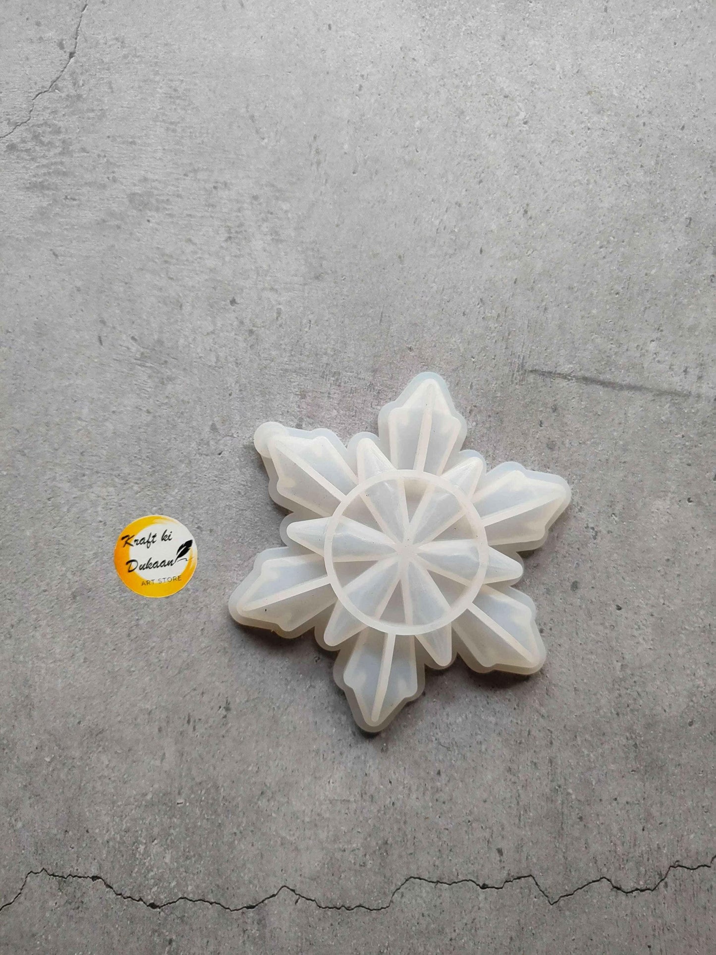 Snowflake-shaped mould with star petal segments, white translucent