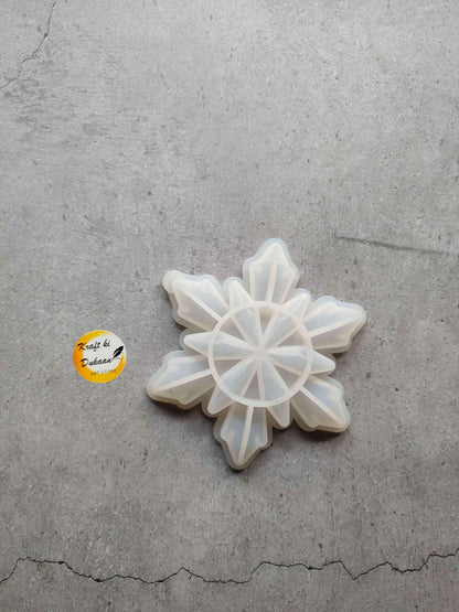 Snowflake-shaped mould with star petal segments, white translucent