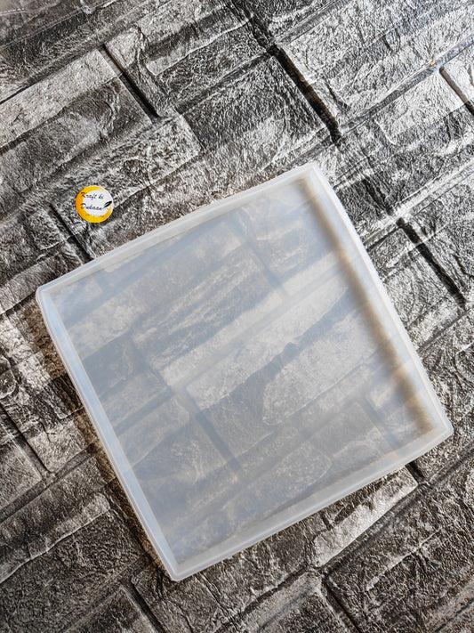 Clear 8 inch silicone square mold on a gray textured surface from Kraft ki Dukaan