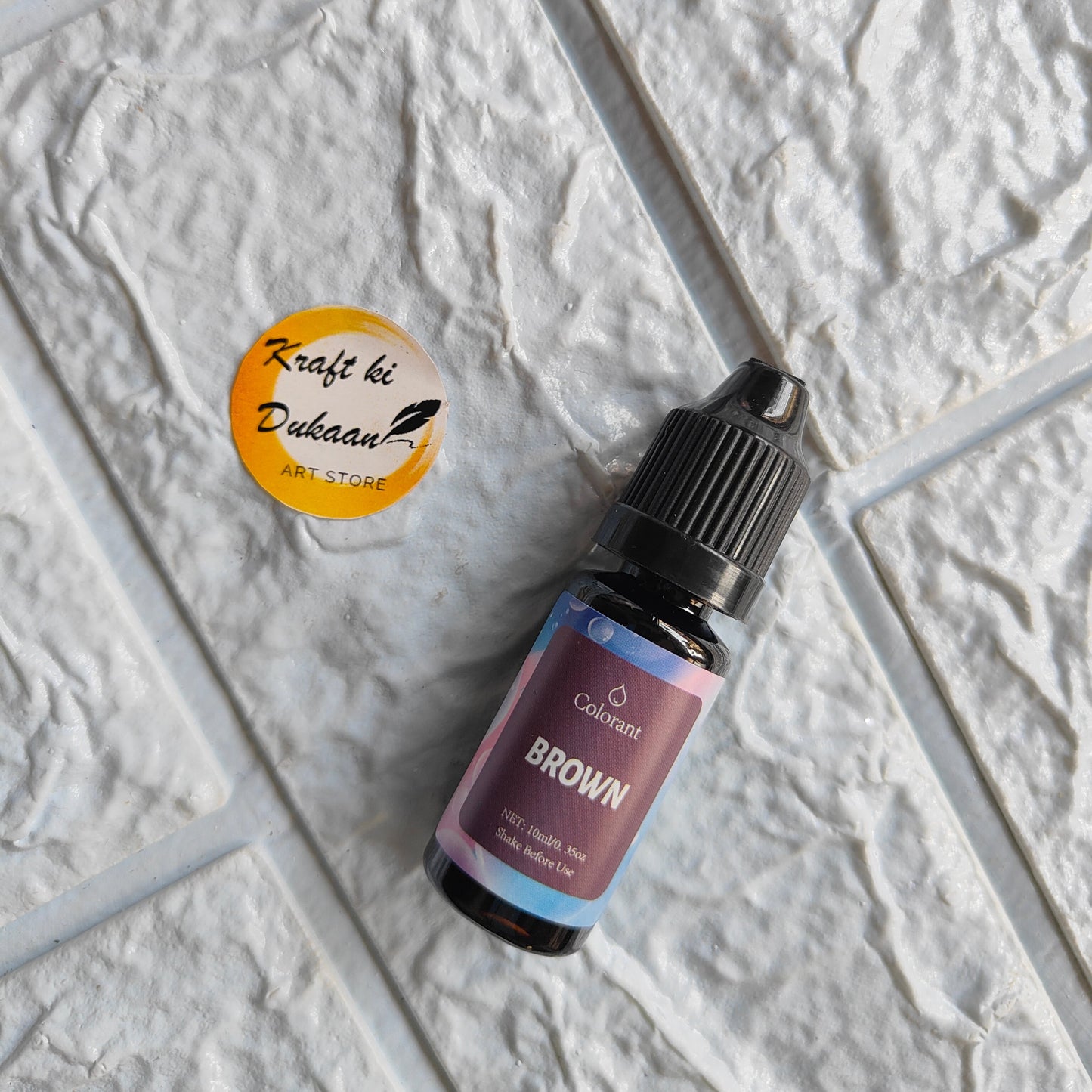Colorant bottle of brown resin pigment colorant for crafting and art projects