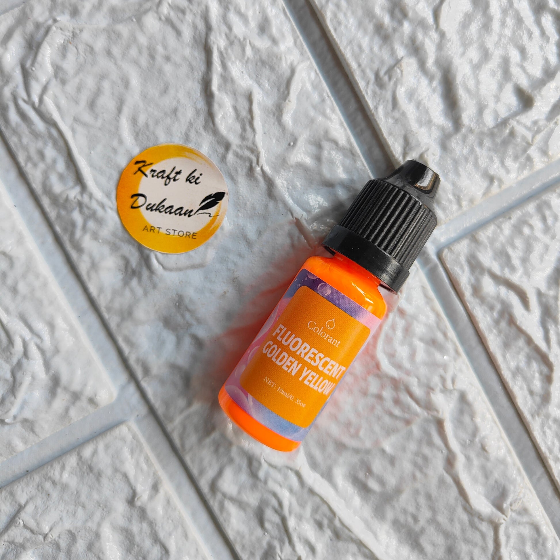 Fluorescent Golden Yellow Resin Pigment Colorant in a bottle from Kraft ki Dukaan for vibrant art projects
